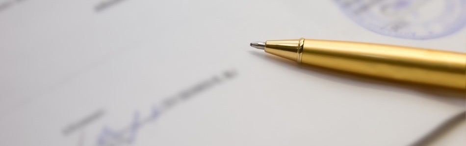 A golden pen on a contract